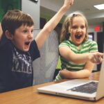 Image of kids using computer, celebrating having a managed service provider (MSP)